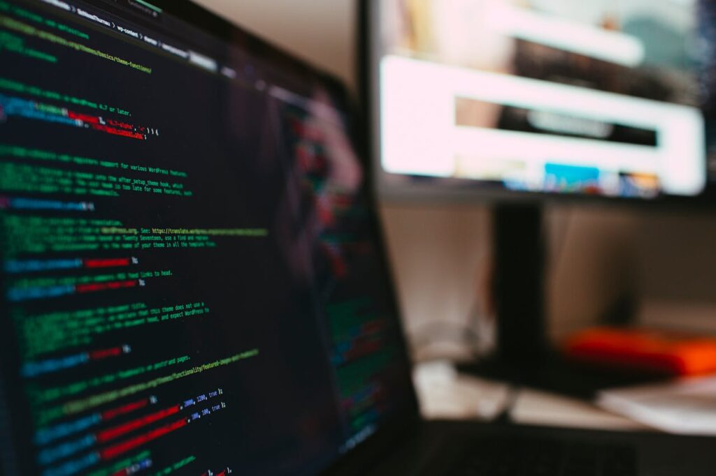 A detailed view of programming code displayed on a laptop screen, depicting a tech workspace.